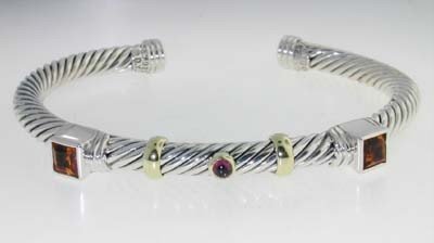 David Yurman 14k Yellow Gold/Silver Multi-Stone Bangle: David Yurman 14k Yellow Gold/Silver Multi-Stone Bangle! Bangle's Weight: 30 grams. Multi-Stone are citrine, Garnet. The measurements of the inside Bangle are 51 x 44 mm and the thickness is 5 mm.