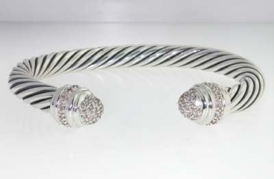 David Yurman Silver Diamond Bangle: David Yurman silver Diamond Bangle. Bangle's Weight :43.5 grams. The weight of diamond:0.66cts, H color,VS clarity. The measurements of the Inside Bangle is 57X45mm and the thickness is 7 mm. There is