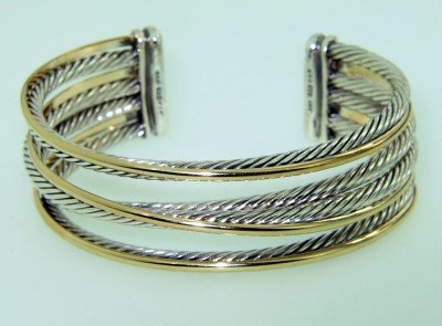 David Yurman 14K Yellow Gold & Silver Bangle: David Yurman 14K Yellow Gold & Silver Bangle Bangle's Weight : 48 grams. The measurements of the Bangle : 51 x 45 mm and the thickness is 2 mm. There is Stamp D.Y, 585, 925 on it.