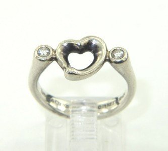 Tiffany & Co. Silver / Diamond Ring.: Tiffany & Co. Silver / Diamond Ring.The total ring's weight is 3.1 grams.The total weight of diamond is 0.1 ct approximately , G color, VS clarity.The size of the ring: 4.The surface measurements of R