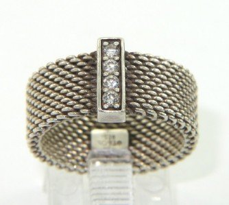 Tiffany & Co. Silver / Diamond Ring.: Tiffany & Co. Silver / Diamond Ring.The total ring's weight is 3.6 grams.The total weight of diamond is 0.1 ct approximately , G color, VS clarity.The size of the ring: 4.The surface measurements of R