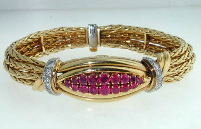 Boucheron 18K Yellow Gold Ruby & Diamond Watch: Boucheron 18K Yellow Gold Ruby & Diamond Watch.The total watch's weight is 55.7 grams.The measurements of watch head is 23 x 9 mm and 6 mm thick.The total weight of Ruby: 2 cts.The total weight of Dia