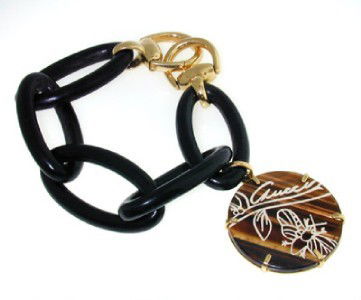 Gucci 18K Yellow Gold, Ebony & Tigereye Bracelet: Gucci 18K Yellow Gold, Ebony & Tigereye Bracelet The total bracelet weight is 47.1 grams. The size of Tigereye: 33 mm The lengtht of bracelet: 6.5"