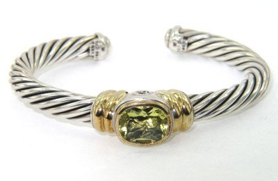 David Yurman Silver/14K Yellow Gold Citrine Bangle: David Yurman Silver/14K Yellow Gold Lemon Citrine Bangle.The total Bangle 's weight is 48.4 grams.The measurement of lemon citrine: 12 x 10 mm.The bangle size is 52 x 39 mm. 6 mm in thickness.