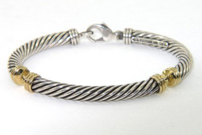 David Yurman Silver/14K Yellow Gold Bangle: David Yurman Silver/14K Yellow Gold Bangle.The total Bangle 's weight is 26.3 grams.The bangle size is 47 x 38 mm. 4 mm in thickness.