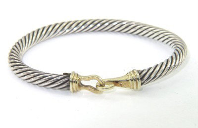 David Yurman Silver Cable Bangle With 18K Yellow Go: David Yurman Silver Cable Bangle With 18K Yellow Gold Buckle Clasp.The total Bangle 's weight is 27.3 grams.The bangle size is 47 x 41 mm. 4 mm in thickness.
