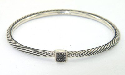 David Yurman Silver Black Diamond Bangle: David Yurman Silver Black Diamond Bangle.The total Bangle's weight is 11.4 grams.The total black diamond weight is 0.09 cts approxmiately. SI clarity.The bangle size is 48 x 48 mm. 2 mm in thickness.