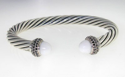 David Yurman Silver, White Coral & Black Diamond Ba: David Yurman White Coral & Black Diamond Bangle in Silver.The total Bangle 's weight is 32.4 grams.The total Black diamond weight: 1 cts.The size of the white coral is 7 mm, each.The bangle size is 53