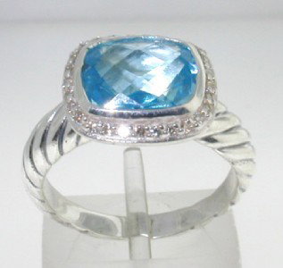 David Yurman Silver, Blue Topaz & Diamond Ring: David Yurman Silver, Blue Topaz & Diamond Ring.The total ring's weight is 4.9 grams.The total weight of the diamond is 0.28 cts approximately, H color VS clarity.The size of the Blue Topaz is 9 x 7 mm
