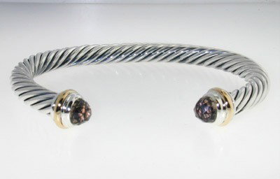 David Yurman Silver,14K Gold, Smoky Topaz Bangle.: David Yurman Silver, 14K Yellow Gold, Smoky Topaz Bangle.The total Bangle's weight is 38.9 grams.The size of Smoky Topaz: 6 mm.The measurement of the inside bangle is 58 x 47 mm, Thickness: 6 mm.