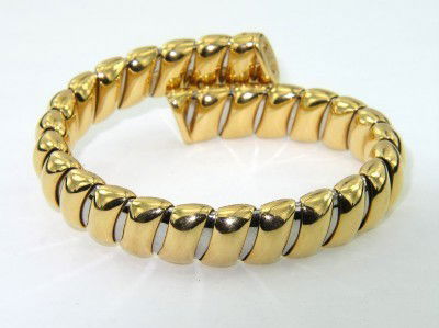 Bvlgari 18K Yellow Gold Bangle: Bvlgari 18K Yellow Gold Bangle. The total weight of bangle is 51.6 grams The size of Bangle is 54 - 81 x 47 mm, The measurements on the surface of Bangle : 6 mm thick, 12 mm wide.