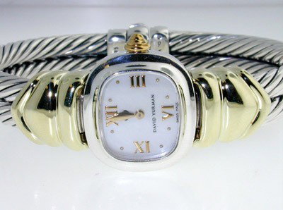David Yurman 14K Yellow Gold and Silver Watch: David Yurman 14K Yellow Gold and Silver Watch.watch's Weight: 60.2 grams.The measurement of watch's head: 9 x 20 and 8 mm in thickness.The measurements of the Inside watch's Bangle is 48 x 36 mm and 9