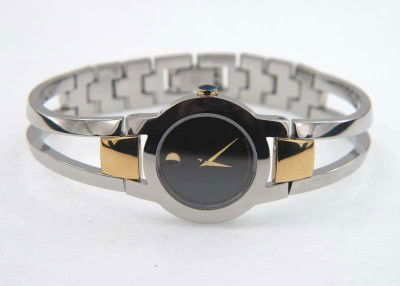 Movado Stainless Steel & Gold Plated Watch: Movado Stainless Steel & Gold Plated Watch.The total watch's weight is 39.4 grams.The measurements of the watch head is 17 x 23 mm and 4 mm thick.The length of watch: 6.5".Swiss Made.Water Resistant.C