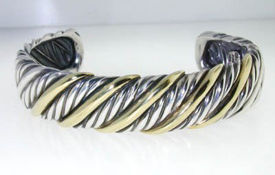 David Yurman Silver /18K Yellow Gold Bangle: David Yurman Silver / 18K Yellow Gold Bangle.Bangle's Weight : 39.3 grams.The measurements of the Bangle are 42 x 52 mm and the thickness is 3 mm.There is Stamp "750" & "925" on it.