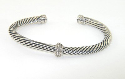 David Yurman Silver Diamond Bangle: David Yurman Silver Diamond Bangle.The total Bangle 's weight is 25.6 grams.The total diamond weight is 0.30 cts approxmiately. I color SI clarity.The bangle size is 59 x 42 mm. 5 mm in thickness.