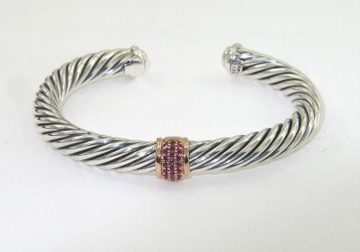 David Yurman Silver/18K Rose Gold Ruby Bangle: David Yurman Silver/18K Rose Gold Ruby Bangle.The total Bangle's weight is 41.4 grams.The total weight ruby: 0.25 cts.The measurement of the inside bangle is 49 x 39 mm, Thickness: 6 mm.There is D.Y',