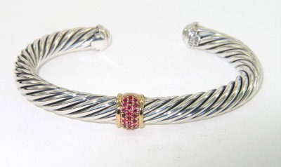 David Yurman Silver/18K Rose Gold Ruby Bangle: David Yurman Silver/18K Rose Gold Ruby Bangle.The total Bangle's weight is 41.2 grams.The total weight ruby: 0.25 cts.The measurement of the inside bangle is 57 x 43 mm, Thickness: 6 mm.There is D.Y',