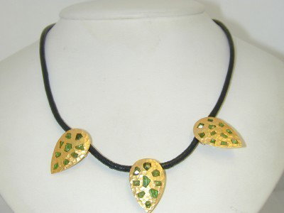 Coera 18K Yellow Gold Tsavorite Necklace: Coera 18K Yellow Gold Tsavorite Necklace.The total necklace's weight is 16.6 grams.The total weight of Tsavorite : 2.5 cts, approximately.The size of each charm: 24 x 16mm.The length of the necklace i