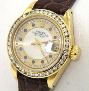 Rolex 18K Yellow Gold Diamond/Sapphire Watch: Rolex 18K Yellow Gold Diamond/Sapphire Oyster Perpetual DateJust, Sapphire Crystal Leather Strap Watch The total watch's weight is 35.8 grams. The total weight of diamond: 1.20 cts. H - I color VS - S