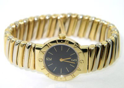 Bvlgari 18K 2-toned Gold Bangle Watch: Bvlgari 18K 2-Toned ( White & Yellow) Gold Bangle Watch.The total watch's weight is 103.6 grams.The measurements of watch head is 25 x 25 mm and 4 mm thick.The measurement of watch: 53 x 40 mm.swiss m