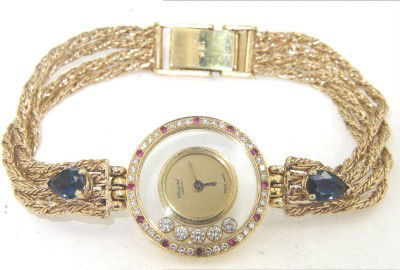 Chopard 18K Gold Happy Diamond, Ruby & Sapphire Wa: Chopard 18K Yellow Gold Happy Diamond, Ruby & Sapphire Watch Watch's Weight: 27.1 grams. Total weight of diamond: 0.56 cts. approximately, G color, VS clarity. Total weight of Ruby is 0.12 cts. approx