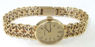 Rolex 14K Yellow Gold Ladies Watch: Rolex 14K Yellow Gold Ladies Watch The total watch's weight is 29.9 grams The size of watch head: 20 x 16 mm and 5 mm thick The length of the watch is 7" Swiss Made Water Resistant Chain is 9 mm wide