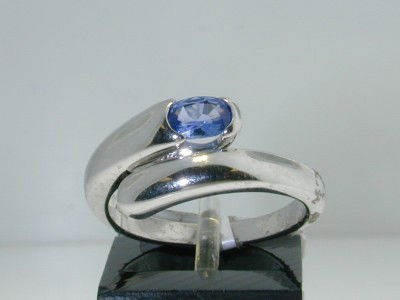 Bvlgari 18K White Gold, Sapphire Ring.: Bvlgari 18K White Gold Sapphire Ring. The total ring's weight is 6.2 grams. The size of the Sapphire is 5 x 4 mm. The size of the ring is 6.75". The measurement of the ring on the surface is 9 mm in w