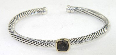 David Yurman Gold / Silver Smoky Topaz Bangle: David Yurman 18K Yellow Gold / Silver Smoky Topaz Bangle The total Bangle's weight is 19.4 grams. The measurement of smoky topaz: 6 x 6 mm. The bangle size is 50 x 43 mm. 3 mm in thickness.