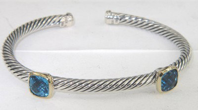 David Yurman 18K Yellow Gold/Silver Blue Topaz Ban: David Yurman 18K Yellow Gold/Silver Blue Topaz Bangle Bangle's Weight: 20.3 grams. The size of the blue topaz is 6 x 6 mm. The measurements of the Bangle: 49 x 42 mm and the thickness is 3 mm. There i