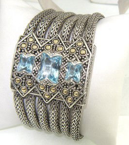 John Hardy Silver / 18K Yellow Gold Blue Topaz Bra: John Hardy Silver Silver / 18K Yellow Gold Blue Topaz Bracelet The total Bracelet's weight is 119.9 grams. The measurement of blue topaz: 12 x 9 - 7 x 6 mm. The length of bracelet: 7". The bracelet is