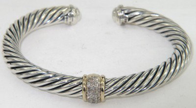 David Yurman Silver / 18K Yellow Gold Diamond Bang: David Yurman Silver / 18K Yellow Gold Diamond Bangle The total Bangle 's weight is 36.8 grams. The total diamond weight is 0.30 cts approxmiately. H color VS clarity The bangle size is 55 x 42 mm. 7 m
