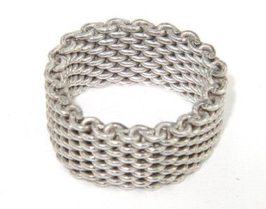 Tiffany & Co Silver Ring: Tiffany & Co Silver Ring. The total ring's weight is 9.1 grams. The measurement of ring 8 mm in wide and 2 mm in thickness. The size of the ring is 6.75.