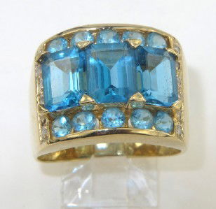 14K Yellow Gold Blue Topaz & Diamond Ring: 14K Yellow Gold Blue Topaz & Diamond Ring. The total ring's weight is 7.9 grams. The size of Blue Topaz: 1 - 7 x 4 mm. Total weight of diamond: 0.24 cts, I color, SI clarity. The size of ring's face: