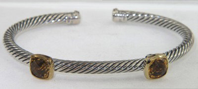 David Yurman 18K Yellow Gold/Silver Citrine Bangle: David Yurman 18K Yellow Gold/Silver Citrine Bangle Bangle's Weight: 20.4 grams. The size of the citrine is 6 x 6 mm. The measurements of the Bangle: 52 x 40 mm and the thickness is 3 mm. There is Stam