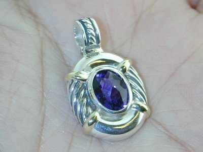 David Yurman Silver, 14K Gold, Amethyst Pendant.: David Yurman Silver, 14K Yellow Gold, Amethyst Pendant. The weight of the Pendant is 6.1 grams. The size of the Amethyst is 10 x 8.5 mm. The size of the pendant is 30 mm in length, 17.5 mm in wide, 6 