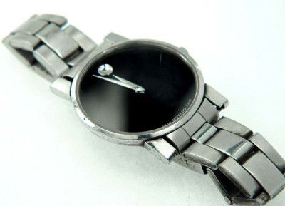 Movado Stainless Steel Watch: Movado Stainless Steel Watch. The total watch's weight is 41.7 grams. The measurements of the watch head is 31 x 31 mm and 4 mm thick. The length of watch: 7.25". Swiss Made. Water Resistant. Chain is