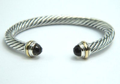 David Yurman Silver,14K Gold, Smoky Topaz Bangle.: David Yurman Silver, 14K Yellow Gold, Smoky Topaz Bangle. The total Bangle's weight is 39.4 grams. The size of smoky topaz: 6 mm The measurement of the inside bangle is 45 x 56 mm, Thickness: 6 mm.