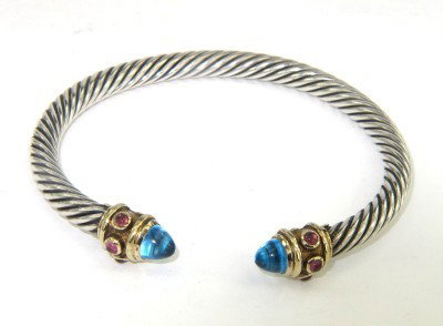 David Yurman 18K Gold/Silver BlueTopaz,Rhodolite Bangle: David Yurman 18K Yellow Gold/Silver Cabochon Blue Topaz & Cabochon Rhodolite Bangle. The total Bangle's weight is 29.7 grams. The measuremnet of cabochon blue topaz: 4 x 4 mm. The size of cabochon rho