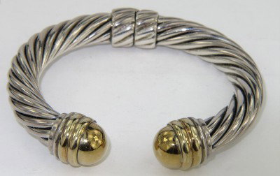 David Yurman 18K Yellow Gold/Silver Bangle: David Yurman 18K Yellow Gold / Silver Bangle. The total Bangle's weight is 51.2 grams. The measuremnet of inside bangle: 50 x 34 mm. The bangle is 8 mm thickness.