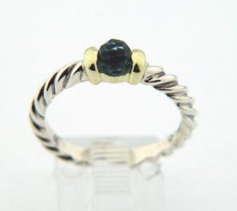 David Yurman Silver /14K Gold, Blue Topaz Ring.: David Yurman Silver/14K Yellow Gold, Blue Topaz Ring. The total ring's weight is 2.7 grams. The size of Blue Topaz is 3 mm. The size of the ring is 5.75