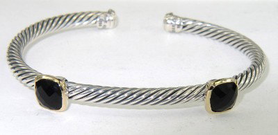 David Yurman 18K Yellow Gold/Silver Onyx Bangle: David Yurman 18K Yellow Gold/Silver Onyx Bangle Bangle's Weight: 20 grams. The size of the Onyx is 6 x 6 mm. The measurements of the Bangle: 50 x 42 mm and the thickness is 3 mm. There is Stamp D.Y, 7