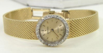 Movado 14K Yellow Gold Diamond Watch: Movado 14K Yellow Gold Diamond Watch. The total watch's weight is 23.4 grams. The total weight of diamond: 0.48 cts., approximately. H color VS clarity. The measurements of the watch head is 15 mm in