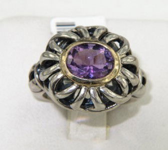 BJC 14K Yellow Gold/Silver Amethyst Ring: BJC 14K Yellow Gold/Silver Amethyst Ring. The total ring's weight is 8.6 grams. The size of amethyst: 8 x 6 mm. The measurement of ring surface: 20 x 17 mm and 6 mm in thickness. The size of the ring