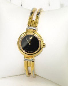 Movado Stainless Steel Bangle Watch: Movado Stainless Steel Bangle Watch. The total watch's weight is 33.5 grams. The measurements of the watch head is 16 x 16 mm and 4 mm thick. The measurement of inside bangle watch: 55 x 40 mm. Swiss