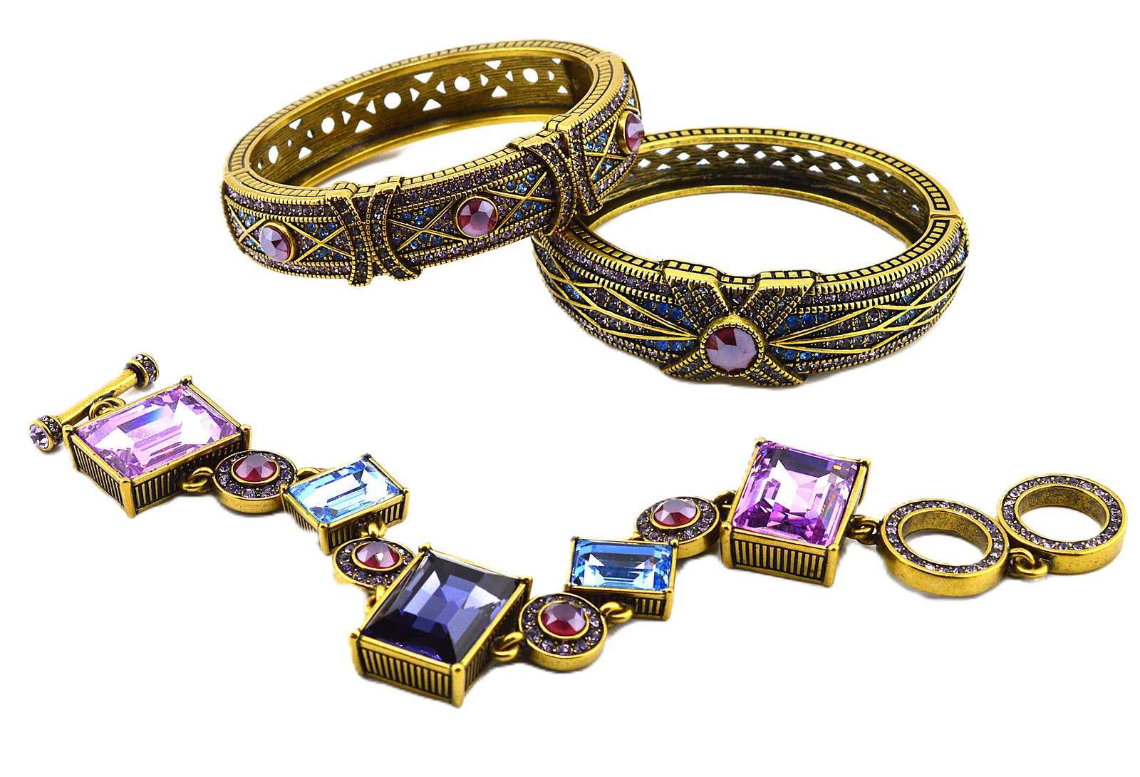 Heidi Daus Triple Bracelet Set Link and Bangles: Heidi Daus Triple Bracelet Set Link and Bangles. Gorgeous triple set of bracelets with rose, pink, blue, purple and amethyst colored crystal. Two hinged cuffs and one link with toggle closure. Link br