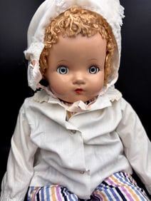 Vintage Composition Doll with Curly Hair and Bonnet