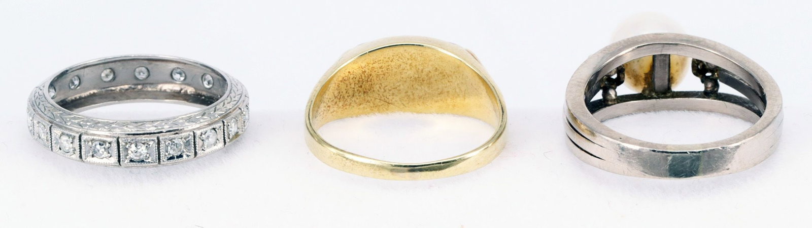 3 rings, all gold, showing signs of wear. - 6