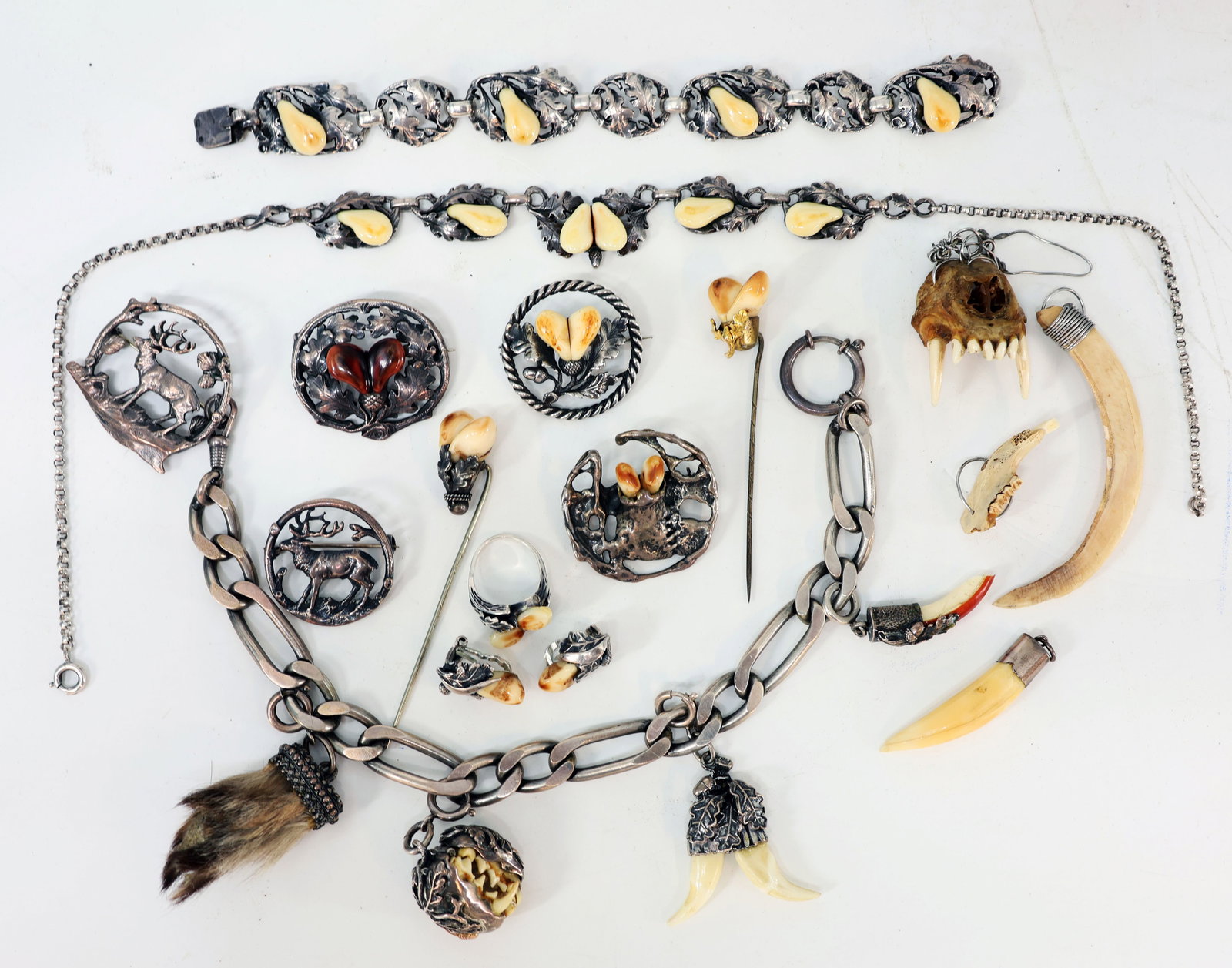 Hunting Jewelry: Assortment of grand jewelry, mostly silver, from a hunter’s collection; shows signs of age and wear. 925 silver: ring, RG49, and earrings, 10.8 g; 835 silver: brooch and charivari with various