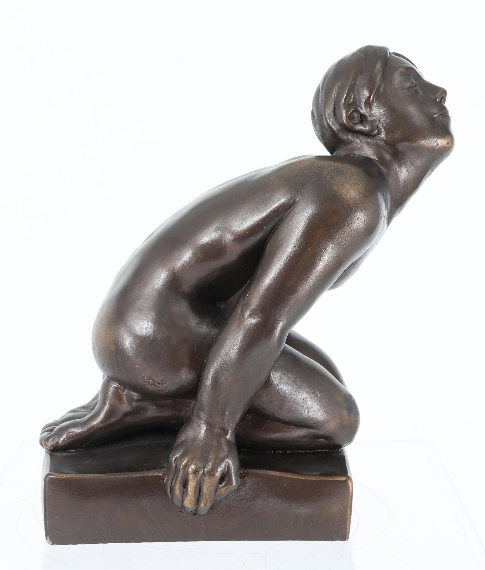 Sculpture, Kneeling Nude: Sculpture, Kneeling Nude, stone cast, patinated bronze; a boy kneels on a low pedestal in a forward-leaning posture, his head tilted slightly back and his hands resting on the pedestal. Marked