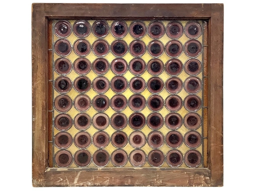 Bullseye Bottle Glass Panel: 35"L x 33 3/4"H stained glass panel featuring bullseye bottle bottom glass, unmarked. EDS aims to describe and photograph all items thoroughly and accurately, however other conditions present may not